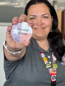 photo of woman veteran holding Proudly Served button